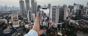 Preview wallpaper city, buildings, aerial view, hand, phone, overview