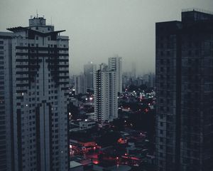 Preview wallpaper city, buildings, aerial view, fog, dusk