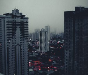 Preview wallpaper city, buildings, aerial view, fog, dusk