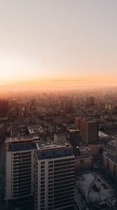 Preview wallpaper city, buildings, aerial view, horizon, fog, dawn