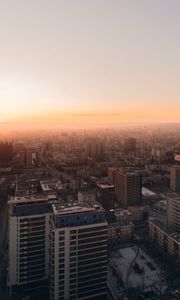 Preview wallpaper city, buildings, aerial view, horizon, fog, dawn