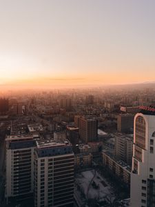 Preview wallpaper city, buildings, aerial view, horizon, fog, dawn