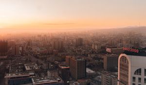 Preview wallpaper city, buildings, aerial view, horizon, fog, dawn