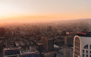 Preview wallpaper city, buildings, aerial view, horizon, fog, dawn