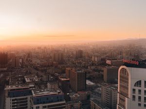 Preview wallpaper city, buildings, aerial view, horizon, fog, dawn