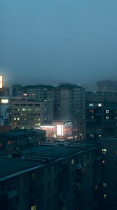 Preview wallpaper city, buildings, aerial view, lights, twilight, fog