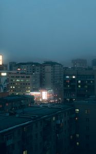 Preview wallpaper city, buildings, aerial view, lights, twilight, fog