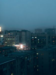 Preview wallpaper city, buildings, aerial view, lights, twilight, fog