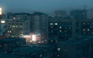 Preview wallpaper city, buildings, aerial view, lights, twilight, fog