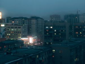 Preview wallpaper city, buildings, aerial view, lights, twilight, fog