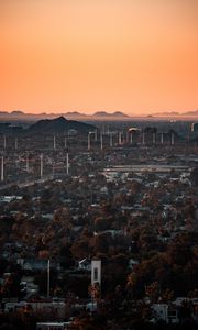 Preview wallpaper city, buildings, aerial view, cityscape, trees, twilight