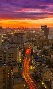 Preview wallpaper city, buildings, aerial view, road, sunset, purple