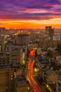 Preview wallpaper city, buildings, aerial view, road, sunset, purple