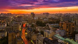 Preview wallpaper city, buildings, aerial view, road, sunset, purple