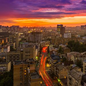 Preview wallpaper city, buildings, aerial view, road, sunset, purple