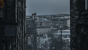 Preview wallpaper city, buildings, architecture, gray, fog, dusk