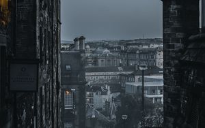 Preview wallpaper city, buildings, architecture, gray, fog, dusk