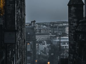 Preview wallpaper city, buildings, architecture, gray, fog, dusk