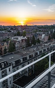 Preview wallpaper city, buildings, architecture, apartments, sunset