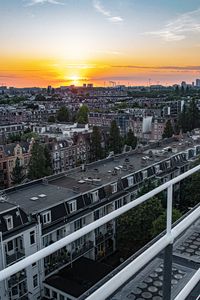 Preview wallpaper city, buildings, architecture, apartments, sunset