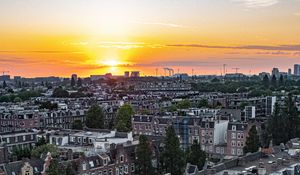 Preview wallpaper city, buildings, architecture, apartments, sunset