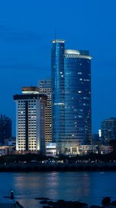 Preview wallpaper city, buildings, architecture, lights, water, twilight