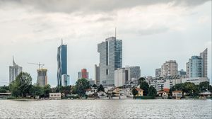 Preview wallpaper city, buildings, architecture, clouds, water