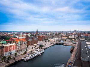 Preview wallpaper city, buildings, architecture, river, boat, aerial view