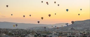 Preview wallpaper city, buildings, balloons, sky, sunset