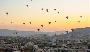 Preview wallpaper city, buildings, balloons, sky, sunset