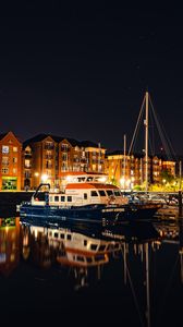 Preview wallpaper city, buildings, boats, pier, night, dark