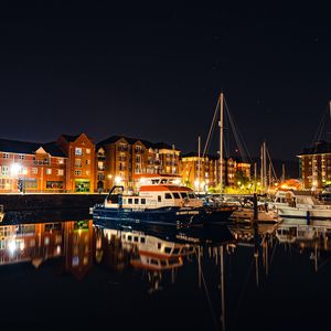 Preview wallpaper city, buildings, boats, pier, night, dark