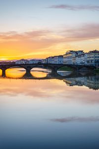 Preview wallpaper city, buildings, bridge, lake, reflection, sunset