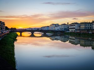 Preview wallpaper city, buildings, bridge, lake, reflection, sunset