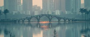 Preview wallpaper city, buildings, bridge, lake, sunset, sun