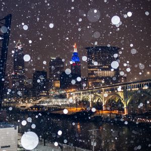 Preview wallpaper city, buildings, bridge, snow, bokeh