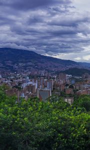 Preview wallpaper city, buildings, cityscape, aerial view, trees, mountains