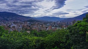 Preview wallpaper city, buildings, cityscape, aerial view, trees, mountains