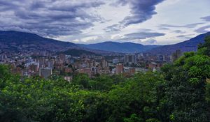 Preview wallpaper city, buildings, cityscape, aerial view, trees, mountains