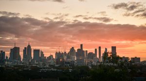 Preview wallpaper city, buildings, clouds, sunset