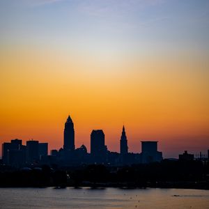 Preview wallpaper city, buildings, coast, dark, dusk