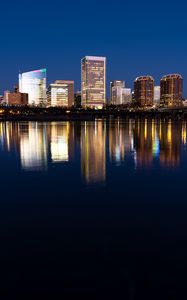 Preview wallpaper city, buildings, coast, water, reflection