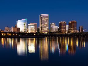Preview wallpaper city, buildings, coast, water, reflection