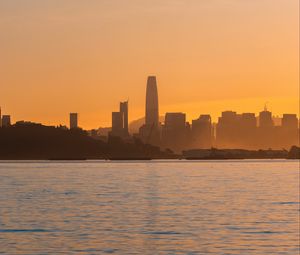 Preview wallpaper city, buildings, coast, fog, sunset