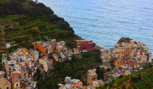 Preview wallpaper city, buildings, coast, slope, sea, horizon