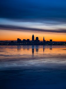 Preview wallpaper city, buildings, coast, sunset, dusk, reflection