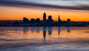 Preview wallpaper city, buildings, coast, sunset, dusk, reflection