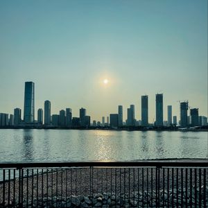 Preview wallpaper city, buildings, embankment, water, twilight