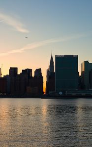 Preview wallpaper city, buildings, evening, water