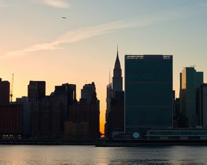 Preview wallpaper city, buildings, evening, water